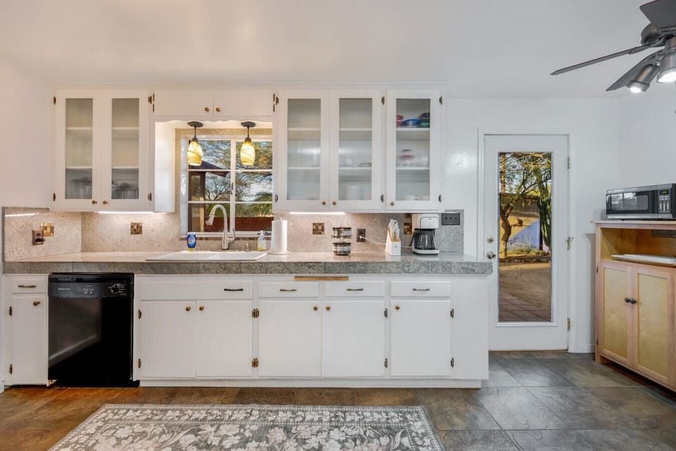 Fully equipped kitchen with plenty of counter space, dishwasher, gas stove, drip coffee maker, microwave, and a cozy breakfast nook just steps away