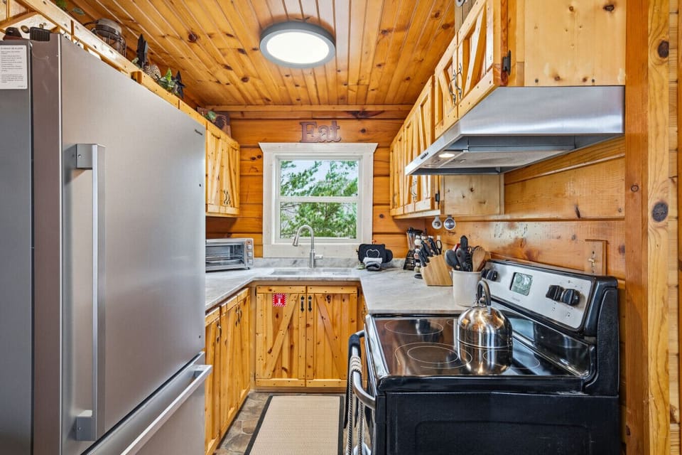 Kitchen | Stainless Appliances, Wood Cabinets & Forest Views