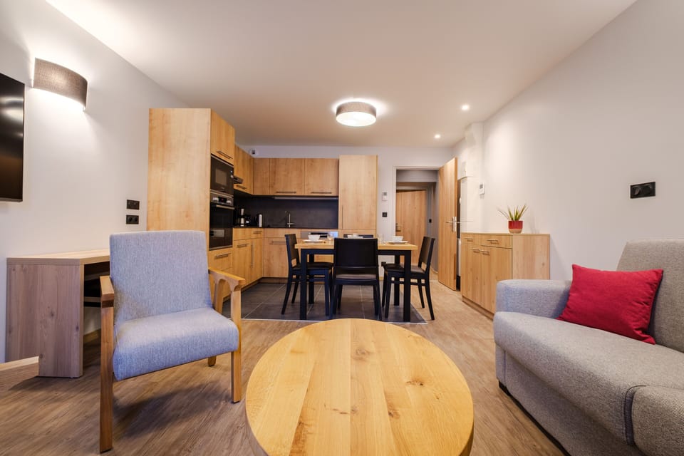 This open-plan space combines a stylish kitchen, dining area, and seating, providing a spacious and welcoming layout for everyday living.