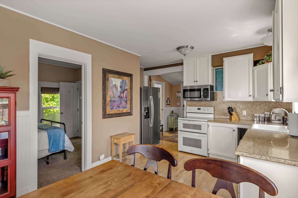 Bright dining area flows into the fully stocked kitchen, creating a welcoming space for family and friends.