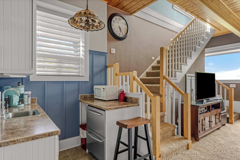 Convenient wet bar with mini fridge and sink makes snacks, drinks, and entertaining a breeze.