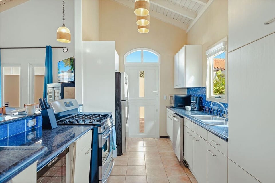 Fully equipped kitchen featuring modern appliances, cookware, essentials, and ample space for meal preparation.