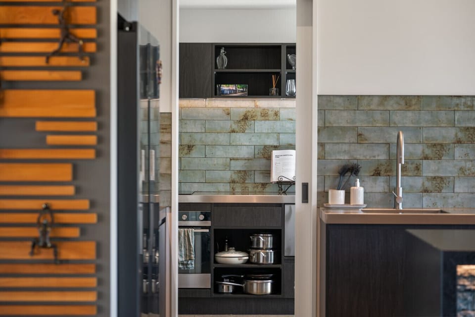The timber-and-tile butler`s pantry keeps the main kitchen spotless while giving you everything you need to prep, pour, and plate like a pro.