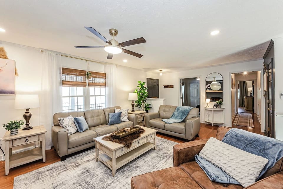 The Bluebell Room offers a queen bed, two dressers including a vanity, and a flat‑screen Amazon TV. Two windows with blackout and noise‑reducing curtains add serenity. Ensuite bathroom and walk‑in closet complete this private, comfortable escape.