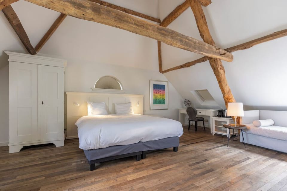 Sink into crisp linens and enjoy timeless, cozy attic charm