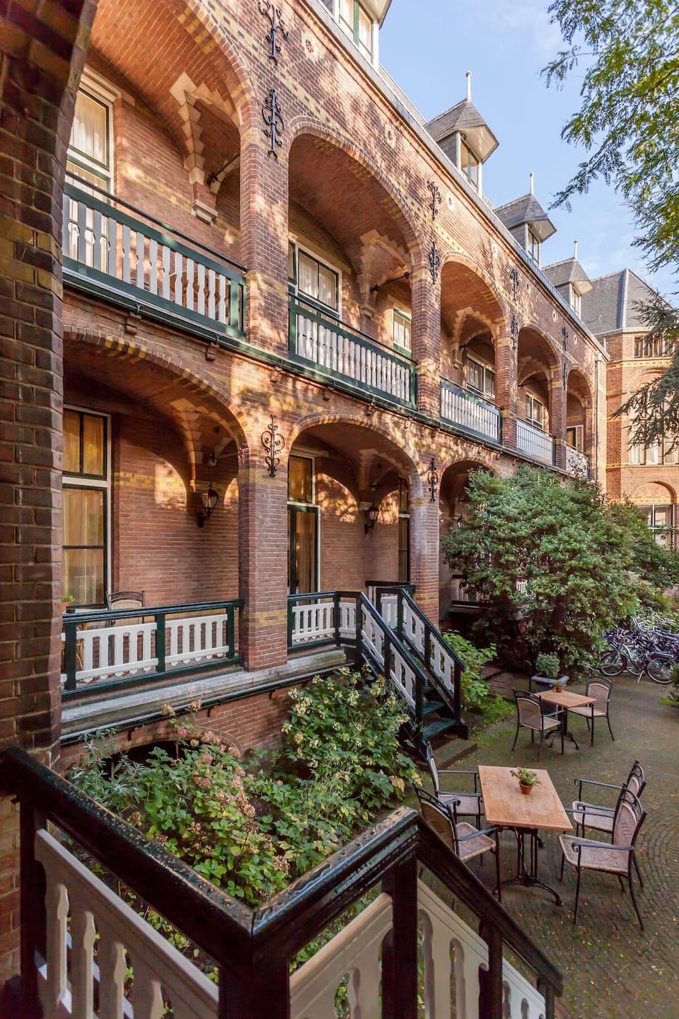 Step outside into a charming courtyard framed by brick arches.