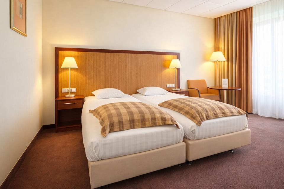 Unwind in a bright twin room with warm lighting.