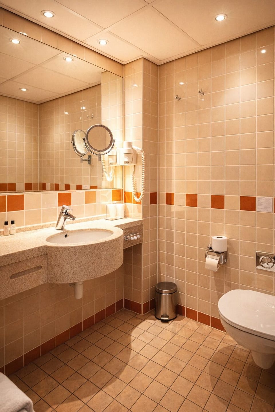 Refresh easily in a spotless bathroom with bright vanity lighting.