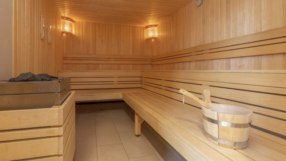 Unwind deeply in warm cedar sauna after a beach day.