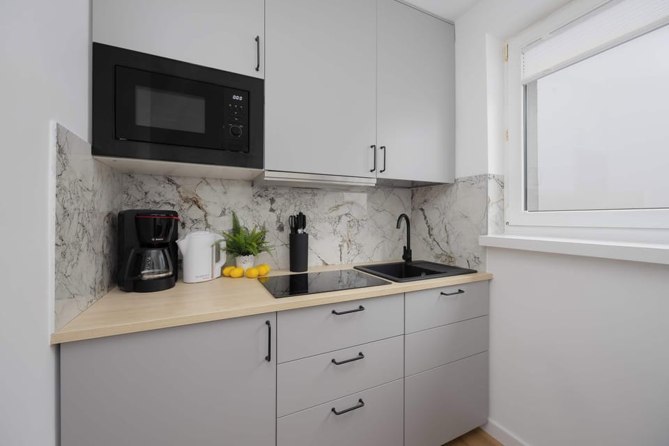 Functional kitchenette with full cabinetry and efficient layout for everyday cooking.