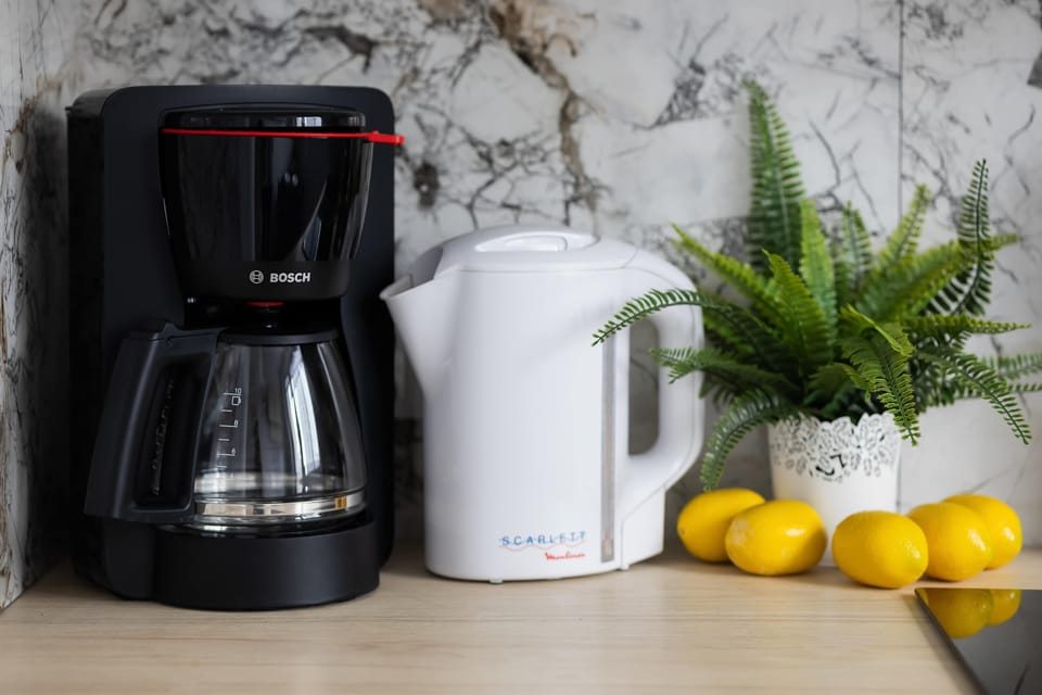 Coffee machine and electric kettle conveniently positioned on the kitchen counter.