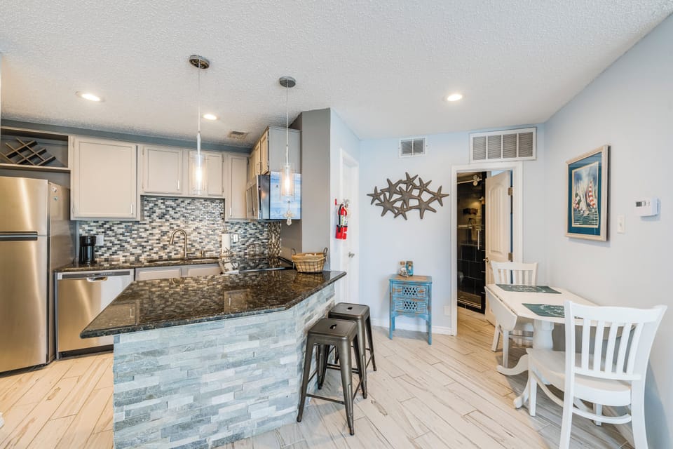 Your fully equipped kitchen features granite counters, stainless appliances, and a breakfast bar where you can sip morning coffee together.