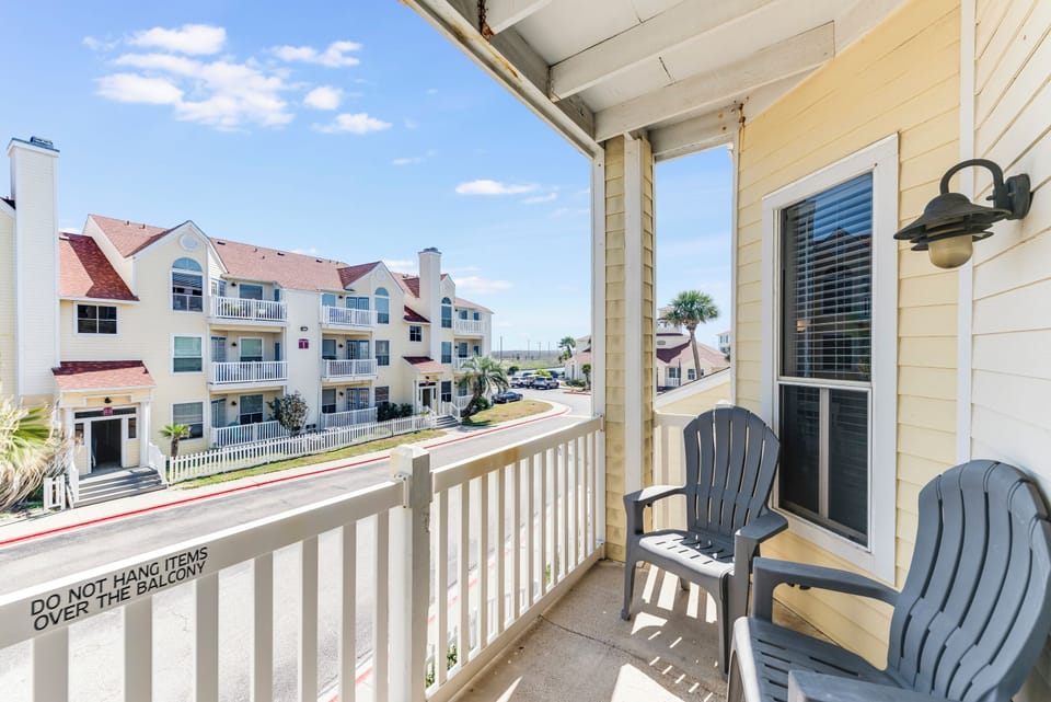 Comfortable balcony with neighborhood views and outdoor seating for relaxing moments during your stay.