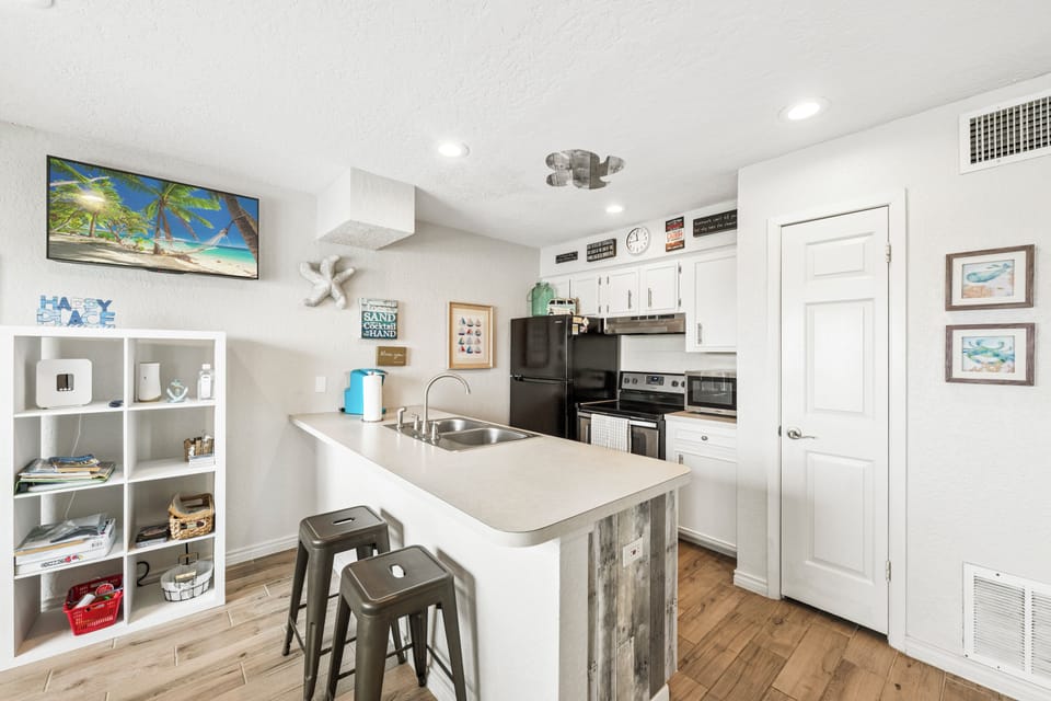 Your bright kitchen features a breakfast bar for quick meals and all the essentials for preparing vacation favorites.