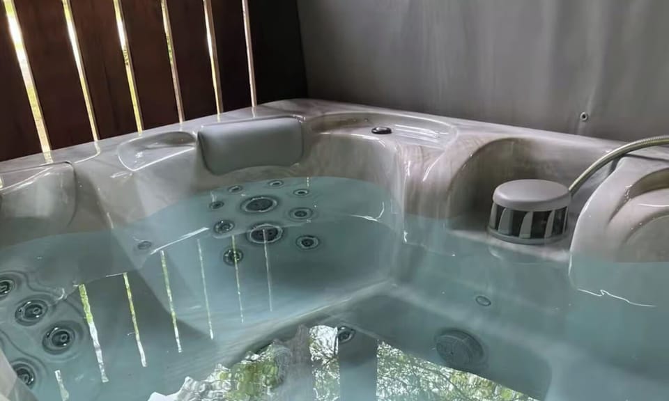 Slip into your private hot tub and let the warm bubbling water melt away stress while morning light filters through.