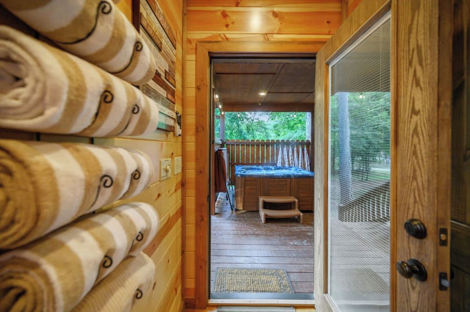 Step from your cozy log cabin into your private hot tub oasis, where warm bubbles await under the forest canopy.