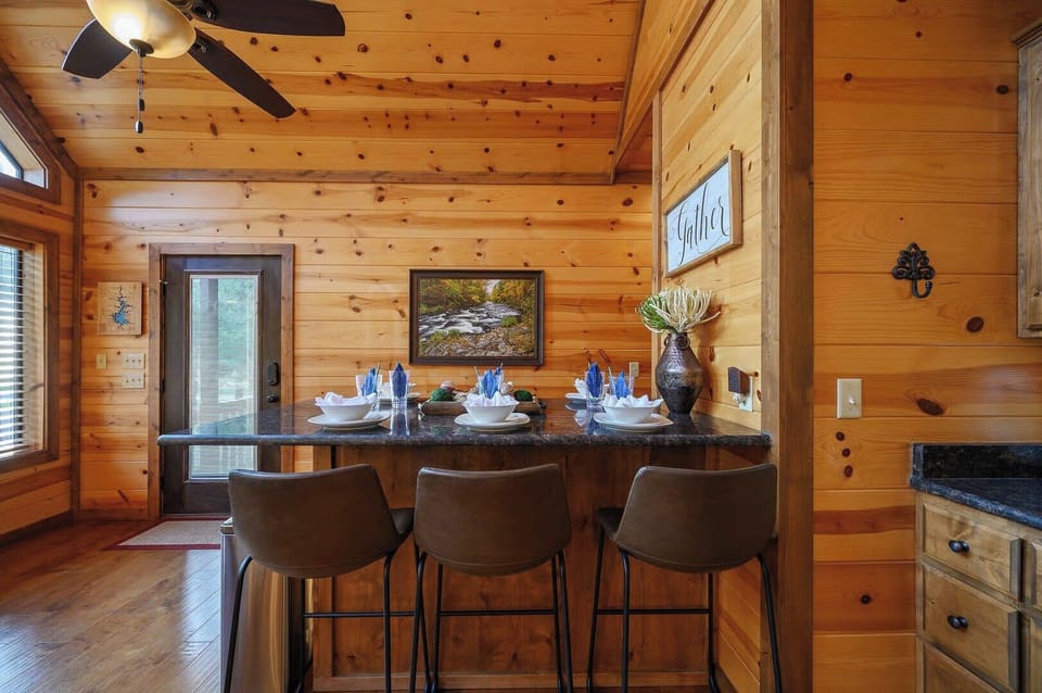 Your rustic dining counter invites memorable meals with warm wood surroundings and mountain cabin charm.