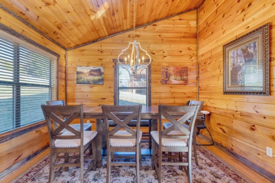 Gather around this rustic dining table where warm wood surrounds you and natural light creates the perfect setting for memorable meals together.