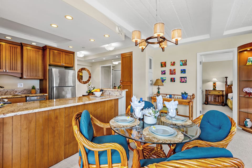 Your spacious kitchen and dining area blends warm wood cabinetry with tropical touches, creating the perfect space for memorable meals together.