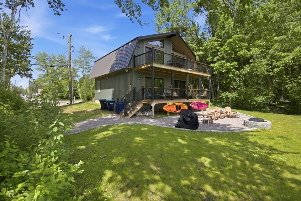 Plenty of outdoor space to gather, with a grassy yard, fire pit, seating, and room to enjoy the fresh air.