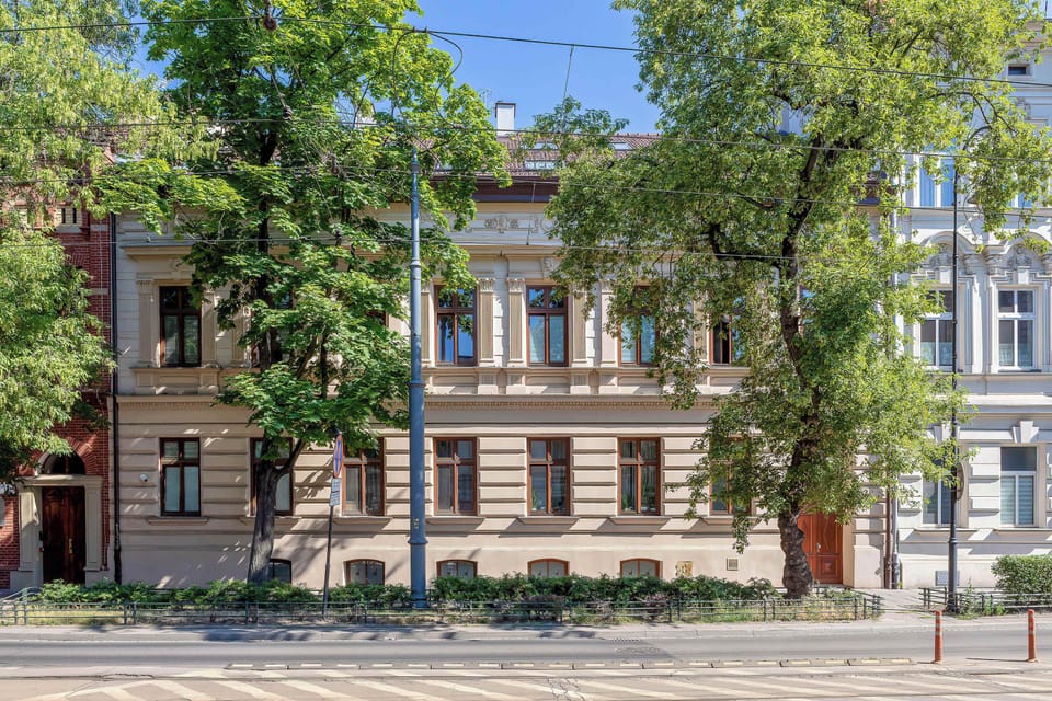 The exterior shot shows a beautifully maintained historic townhouse with a classic facade, nestled in a prestigious and green neighborhood.