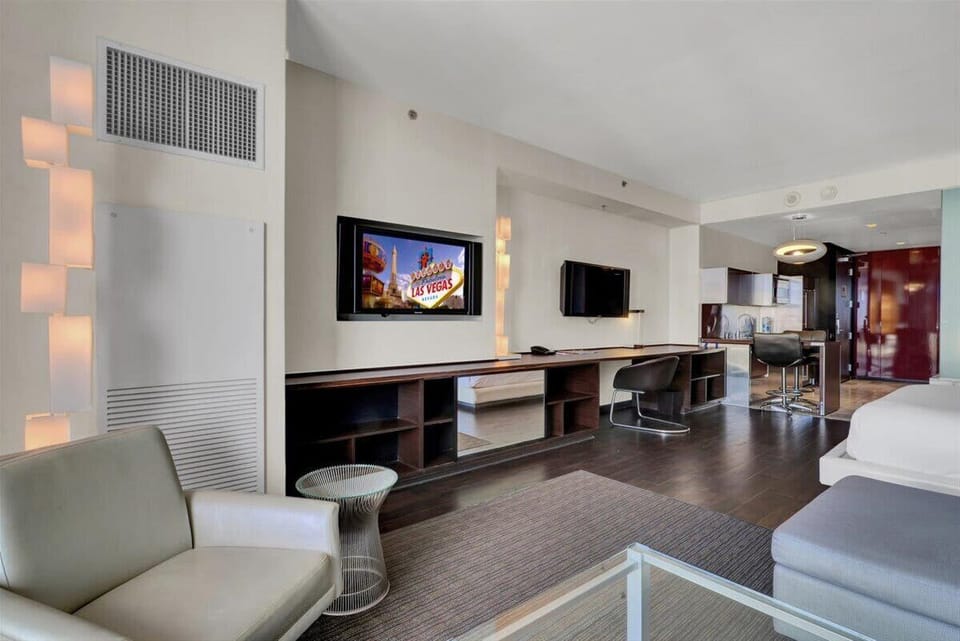 Relax and unwind in the cozy living area with plush seating, smart TV, and stunning city views.
