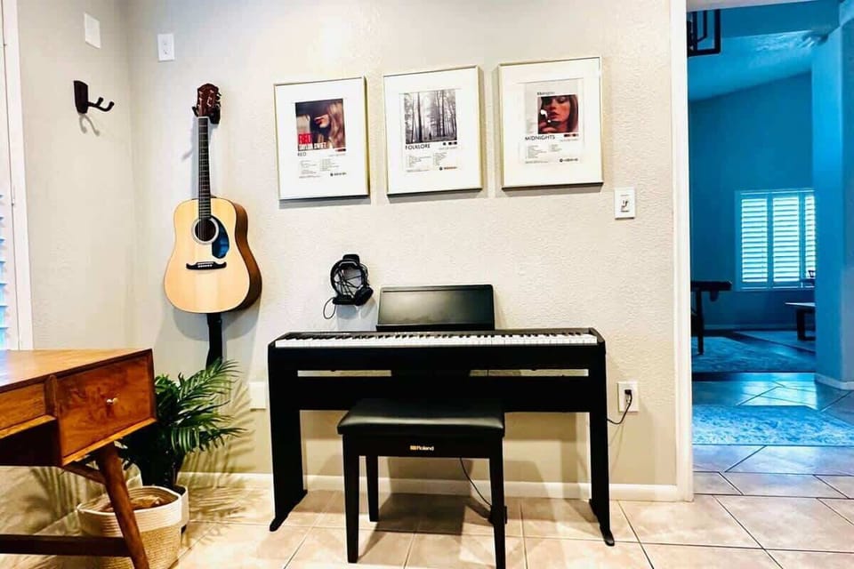 Musical-themed office/den with a full-size sofa bed and instruments.