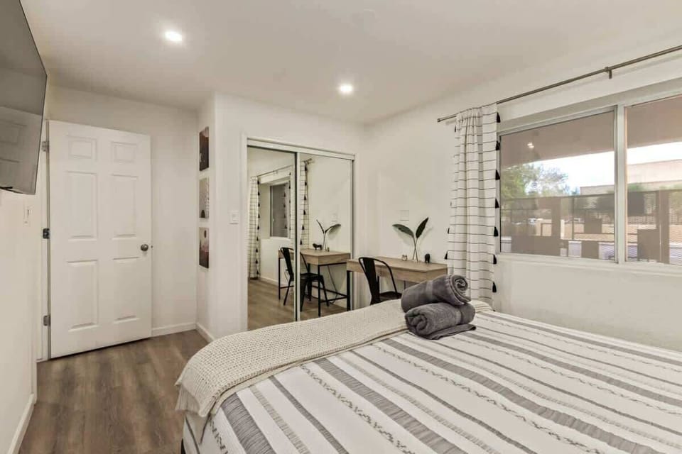 Comfortable bedrooms with queen beds, Smart TVs, soft linens, and calming décor designed for restful nights.