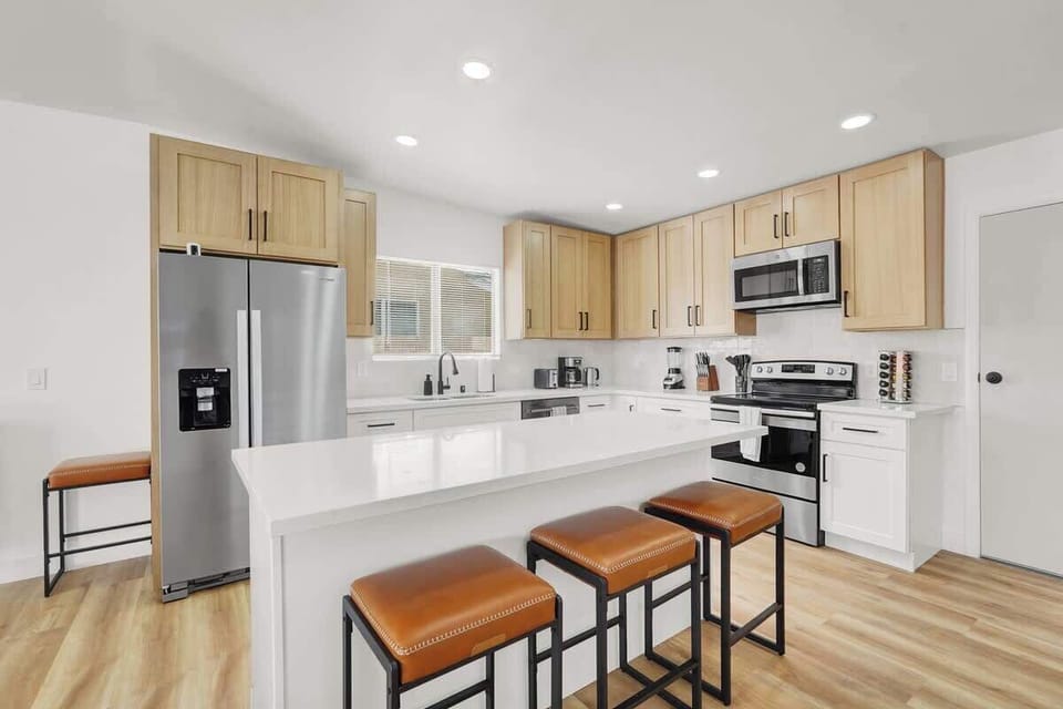 Cook with ease in the fully stocked kitchen featuring modern appliances.