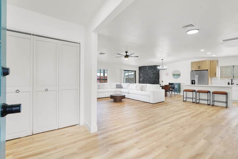 Relax in the spacious living room with a 75" Smart TV and cozy seating.