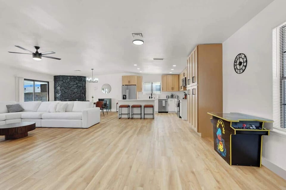 Relax in the spacious living room with a 75" Smart TV and cozy seating.