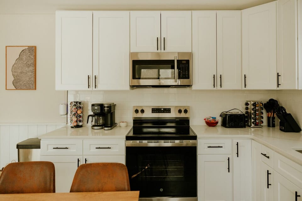 Sleek white kitchen with stainless steel finishes