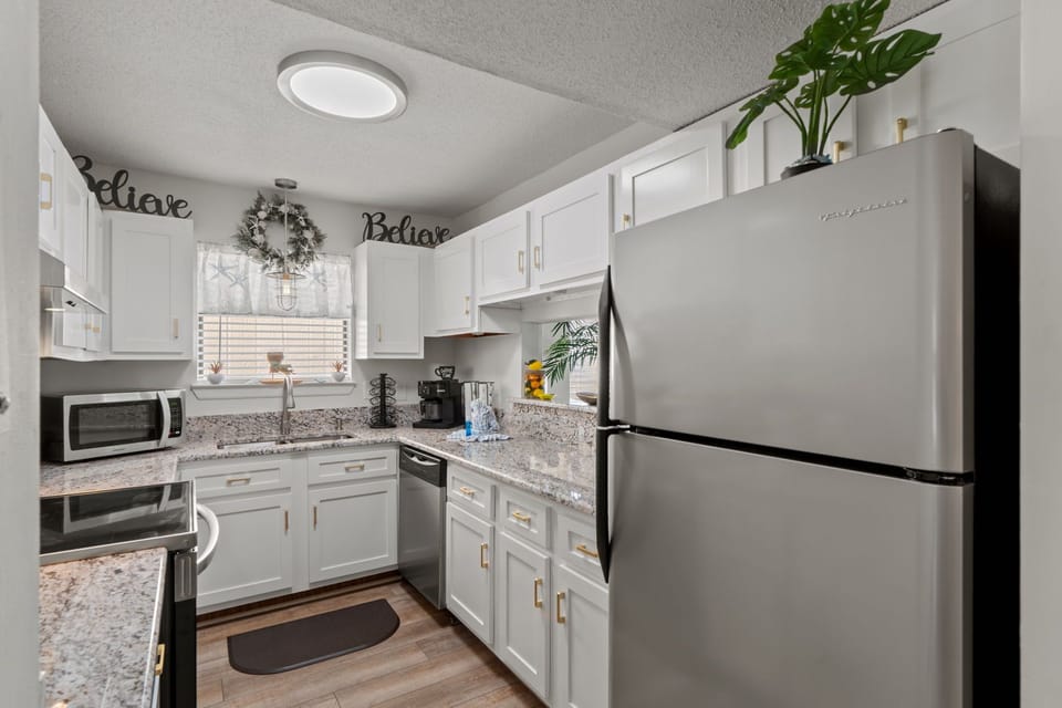 Your fully equipped kitchen awaits with granite counters, stainless appliances, and coffee station—perfect for preparing meals together.