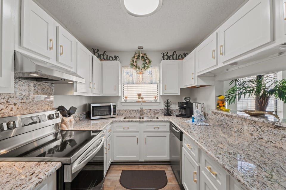 Your fully-equipped kitchen awaits with granite counters, modern appliances, and cheerful touches that make cooking feel like home.