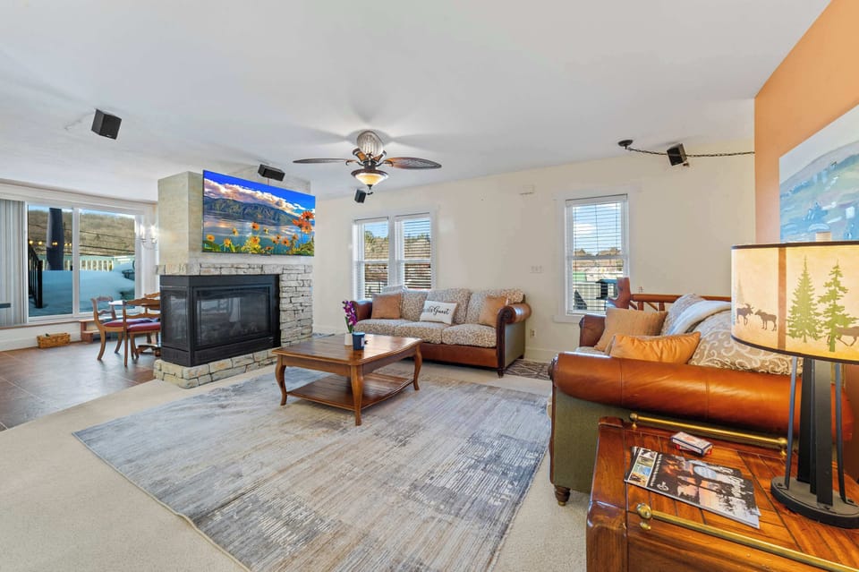 Spacious living space with 65" smart TV and plenty of sitting.