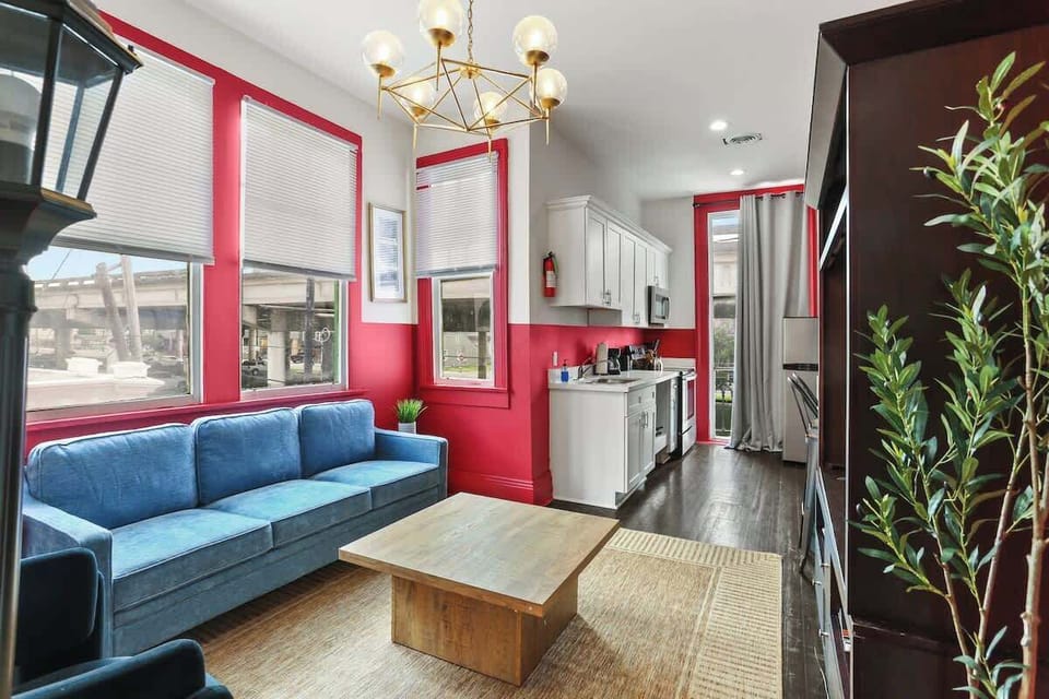 Open living area with comfortable seating, Smart TV, and large windows that fill the space with natural light. Seamlessly connected to the kitchen, creating a bright, inviting space to relax between adventures.