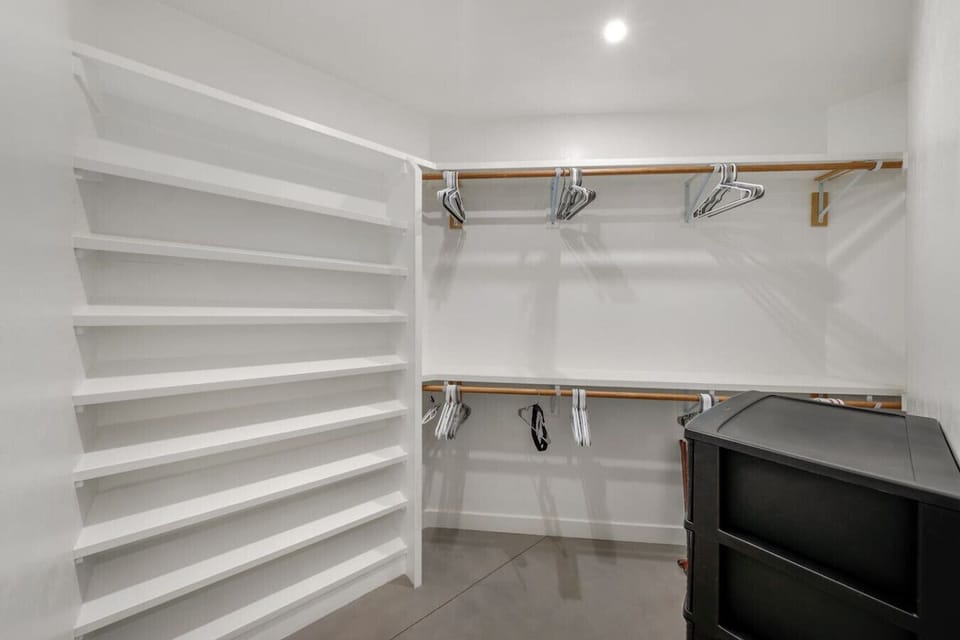 HOUSE: Primary bedroom`s spacious walk-in closet with abundant storage space