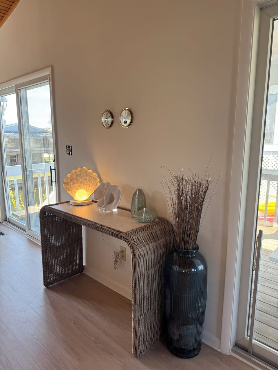 Entry table between two large sliders; 1 to the screen porch and 1 to the raised