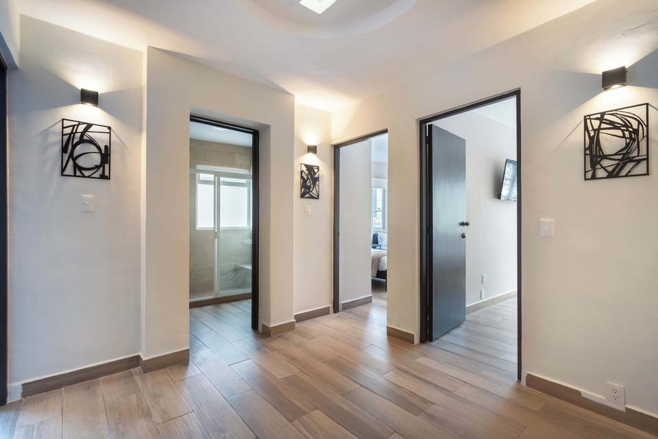 Explore the spacious hallway leading to comfortable bedrooms and modern bathrooms.
