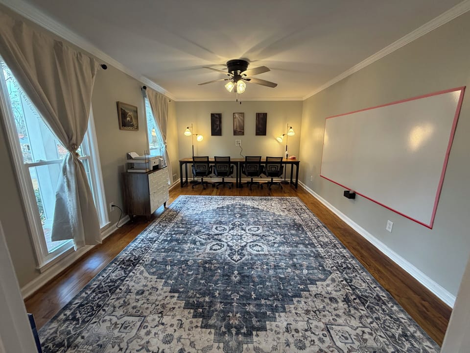 Dedicated office with printer plus 8-player poker table for fun nights.