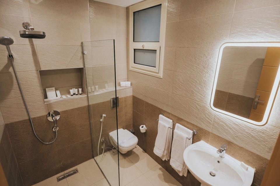 Shower, hair dryer, slippers, towels