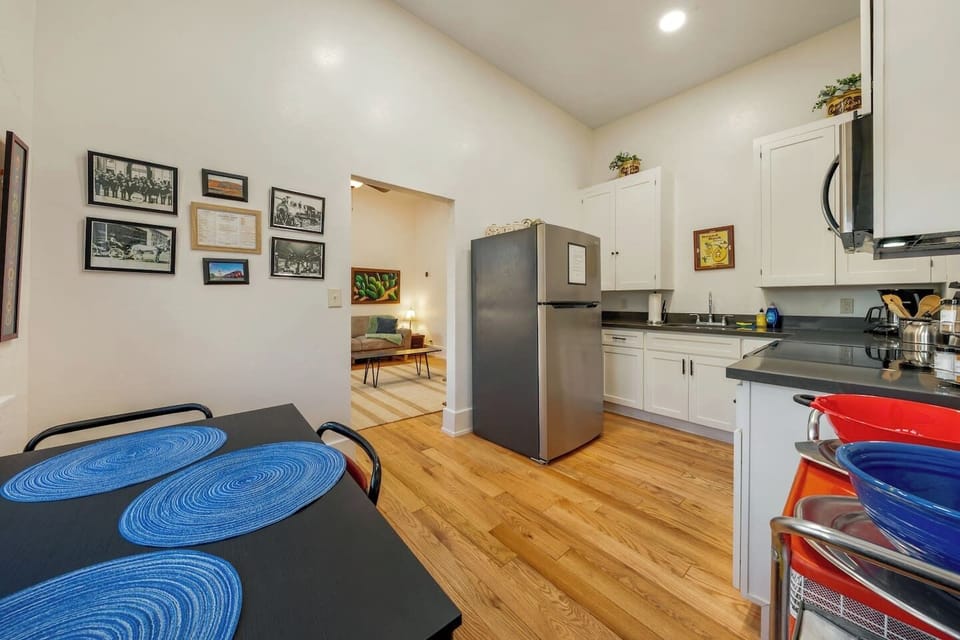 UNIT #2: View of the cozy dining table and well-equipped kitchen, perfect for making meals in your home away from home