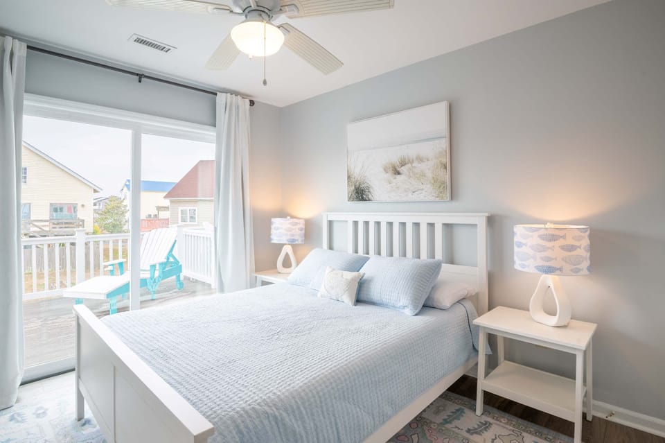 Primary Queen Suite with Slider Doors to Back Deck and wall-mounted smart TV