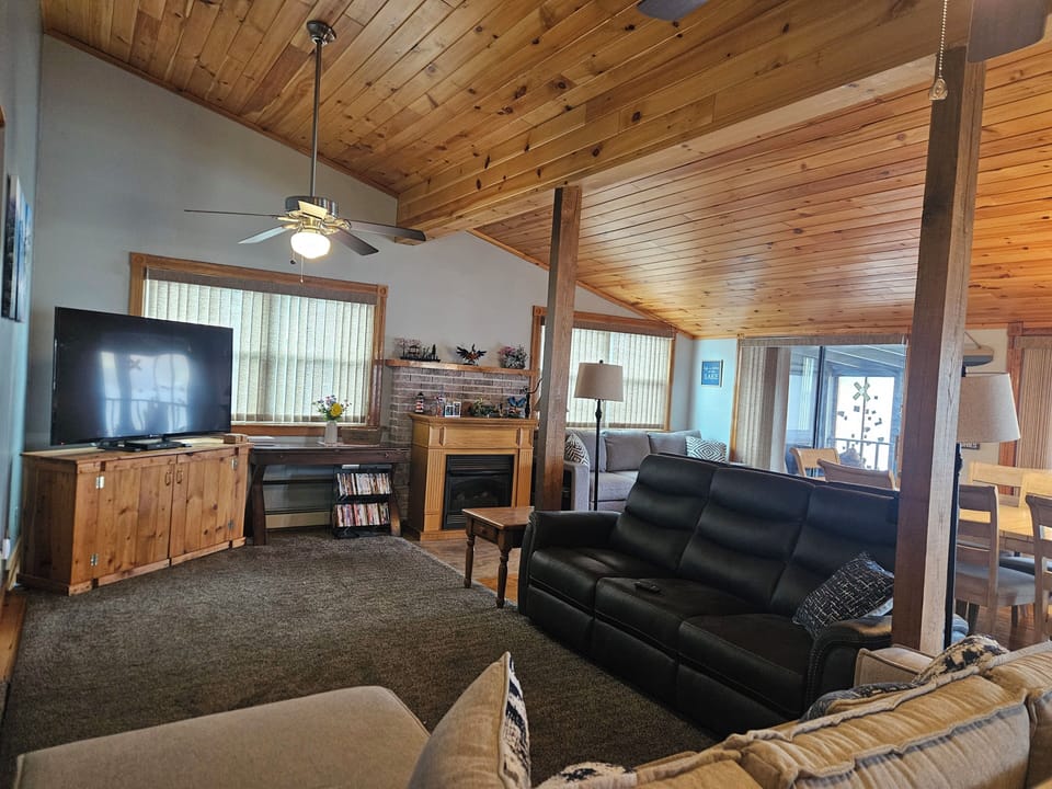 Living Room features 3 couches, fireplace, TV,  and High Ceilings for ambiance!