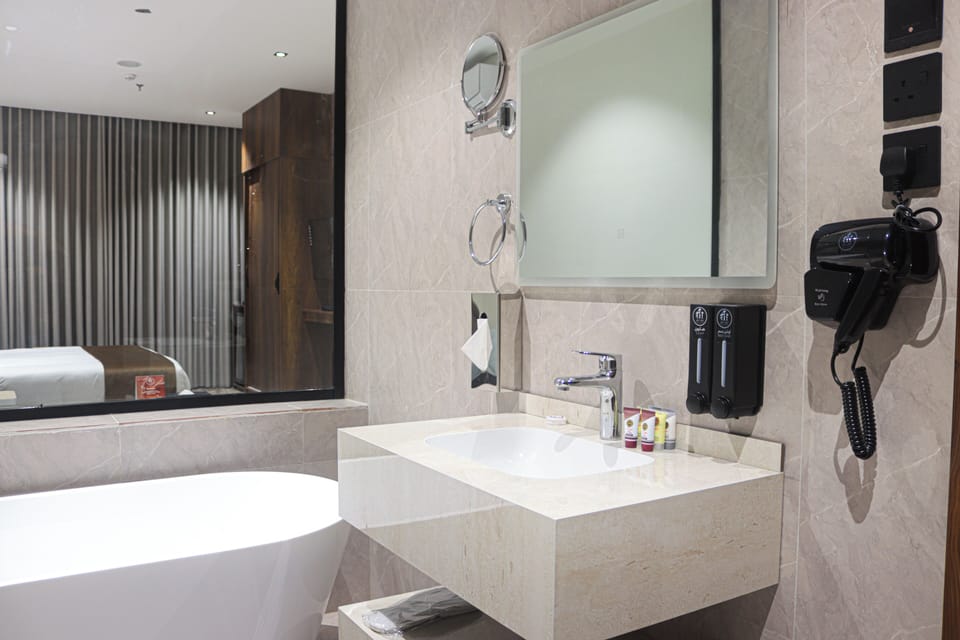 Luxury Studio Suite | Bathroom | Hair dryer, slippers, towels, soap