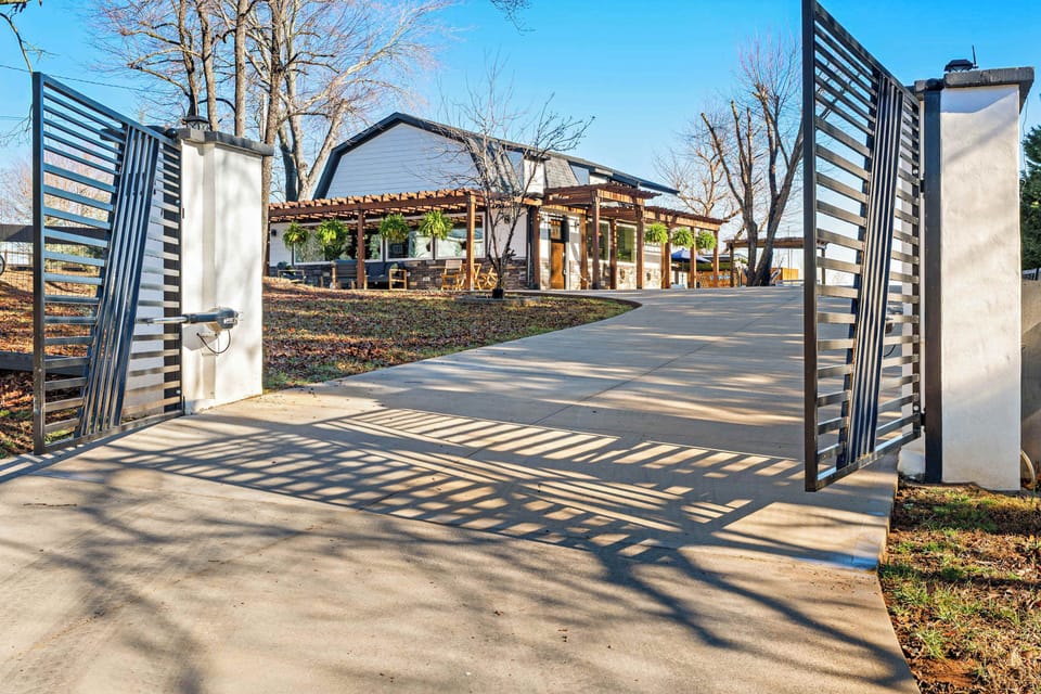 Farmhouse Retreat features a gated driveway with ample parking.
