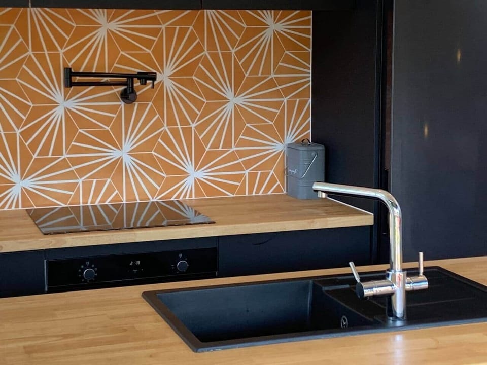 The kitchen features a hot water tap for a quickly served cup of tea and pot filler above the cooktop.  The range hood has smart voice activated lightbulbs. 