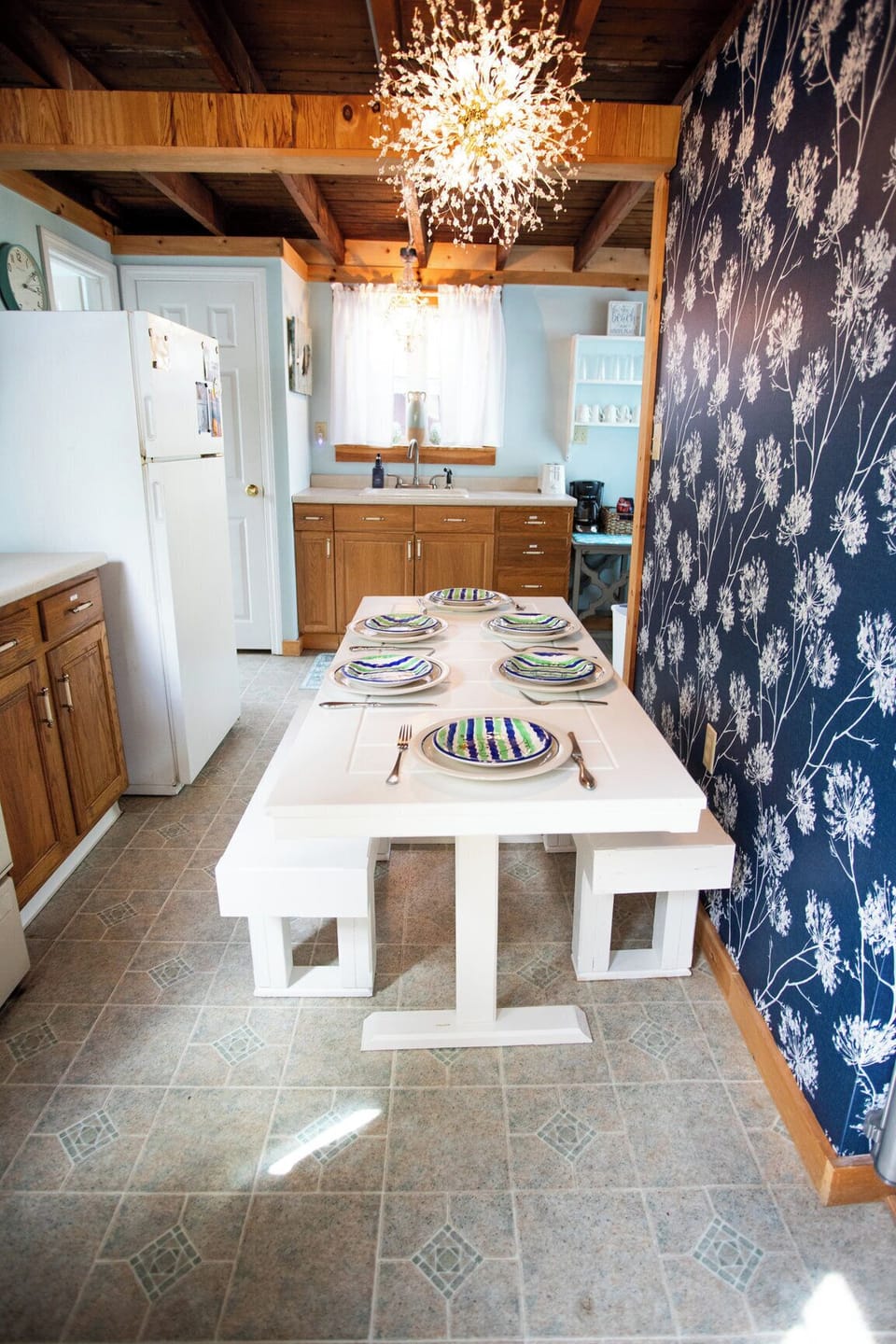 Cottage kitchen with the essentials: stove, fridge, microwave, dishwasher, coffee maker, and charm.