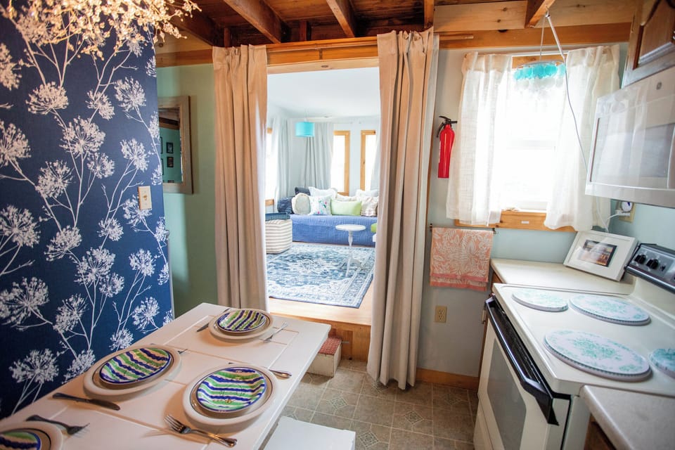 Kitchen opens to the living room, so snacks, stories, and beach plans stay connected.