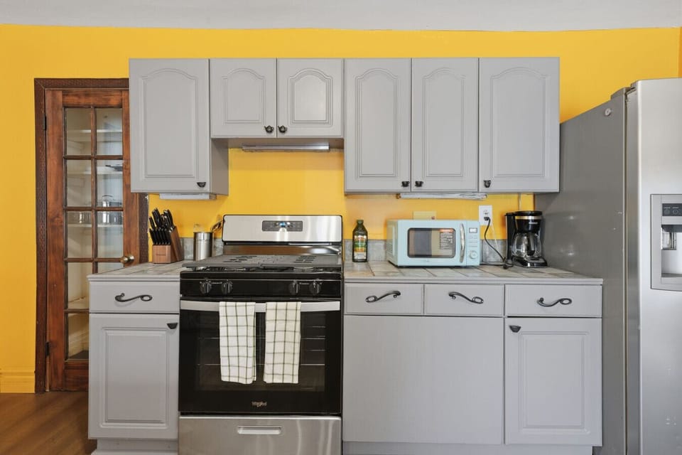 Practical kitchen with ample counter space, microwave, coffee maker and room to cook, host, and move around comfortably.